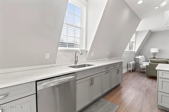 a kitchen with a sink a stove and cabinets