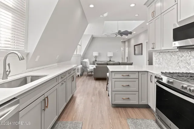 a kitchen with a sink cabinets and wooden floor