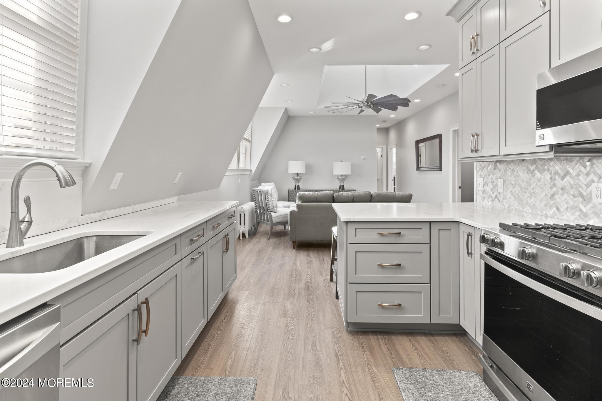 892 Elberon Avenue Long Branch, NJ 07740 - Photo 21 of 50 a kitchen with stainless steel appliances granite countertop a stove and a sink