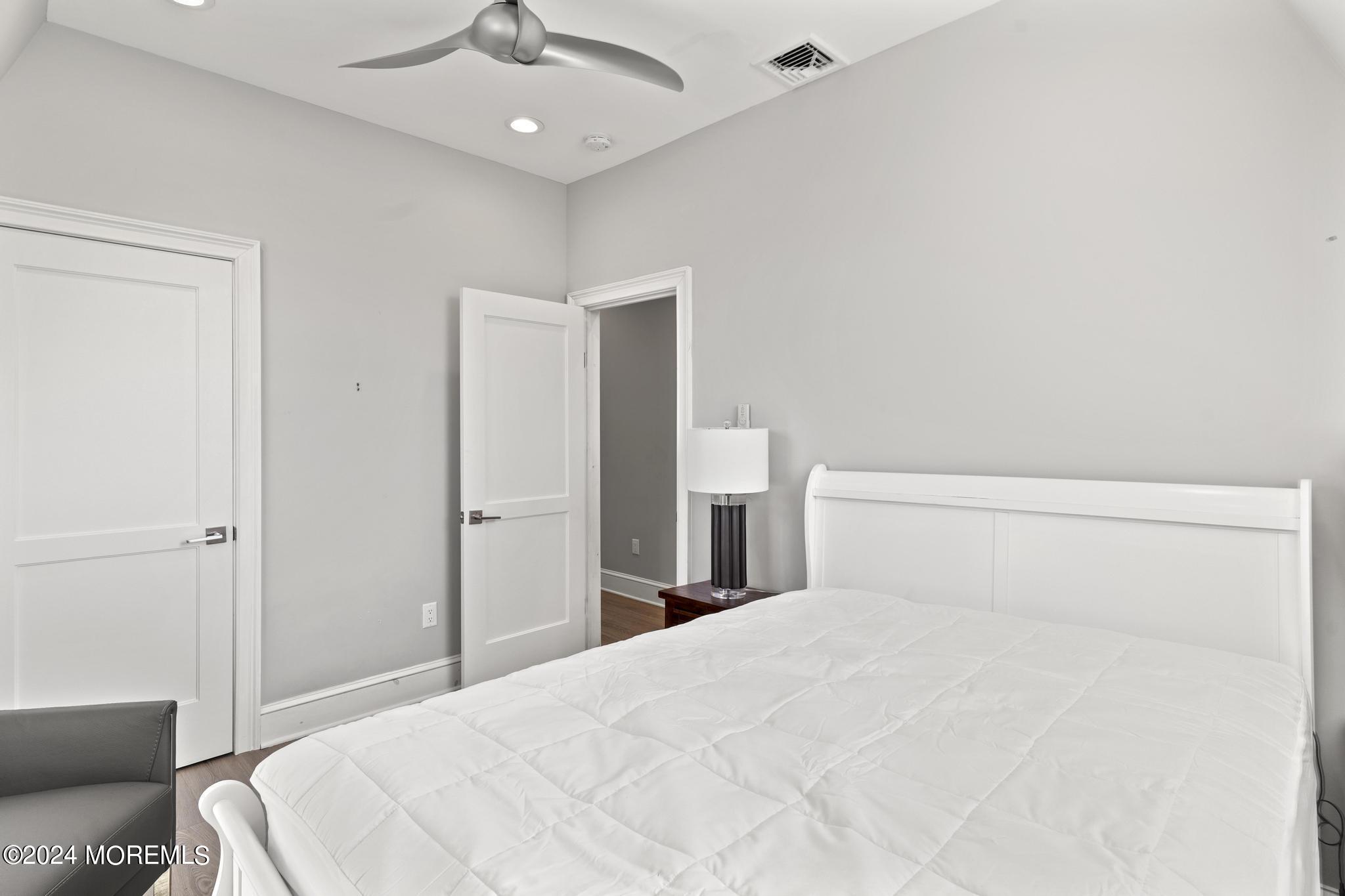 892 Elberon Avenue Long Branch, NJ 07740 - Photo 27 of 50 a bedroom with a bed and a lamp