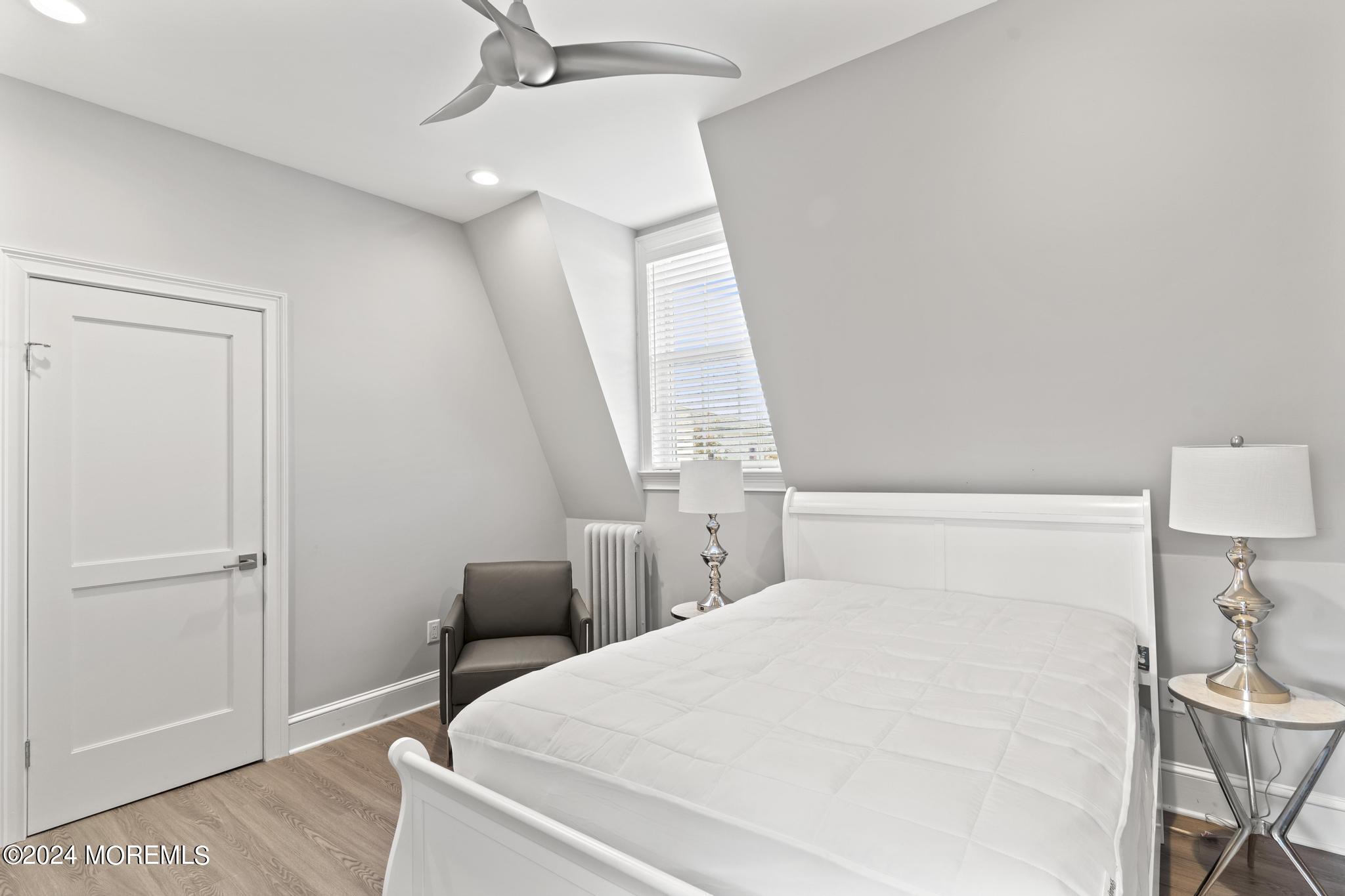 892 Elberon Avenue Long Branch, NJ 07740 - Photo 28 of 50 a bedroom with a bed and a lamp