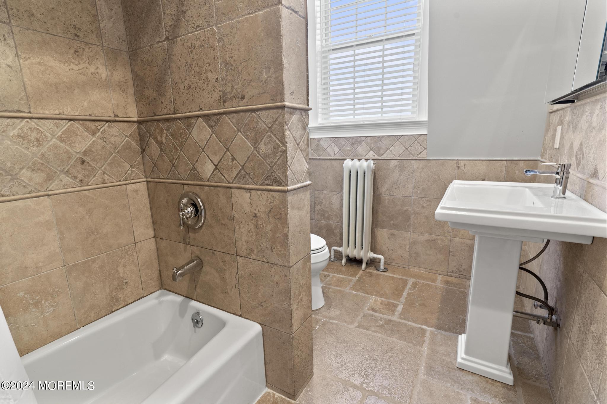 892 Elberon Avenue Long Branch, NJ 07740 - Photo 31 of 50 a bathroom with a sink and a bathtub