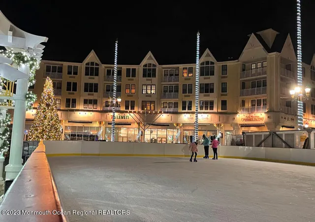 a front view of an apartment building with retail shops