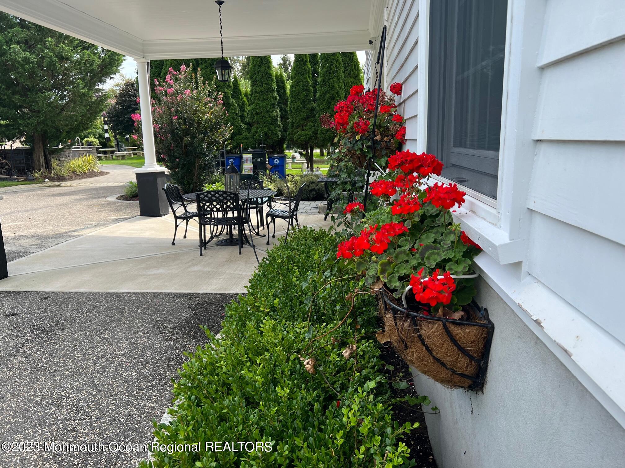 892 Elberon Avenue Long Branch, NJ 07740 - Photo 47 of 50 a table and chairs in the patio in front of a house
