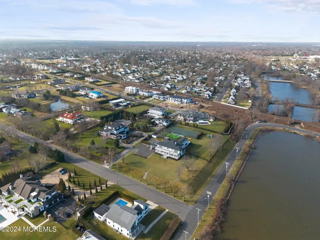 an aerial view of residential houses with city view