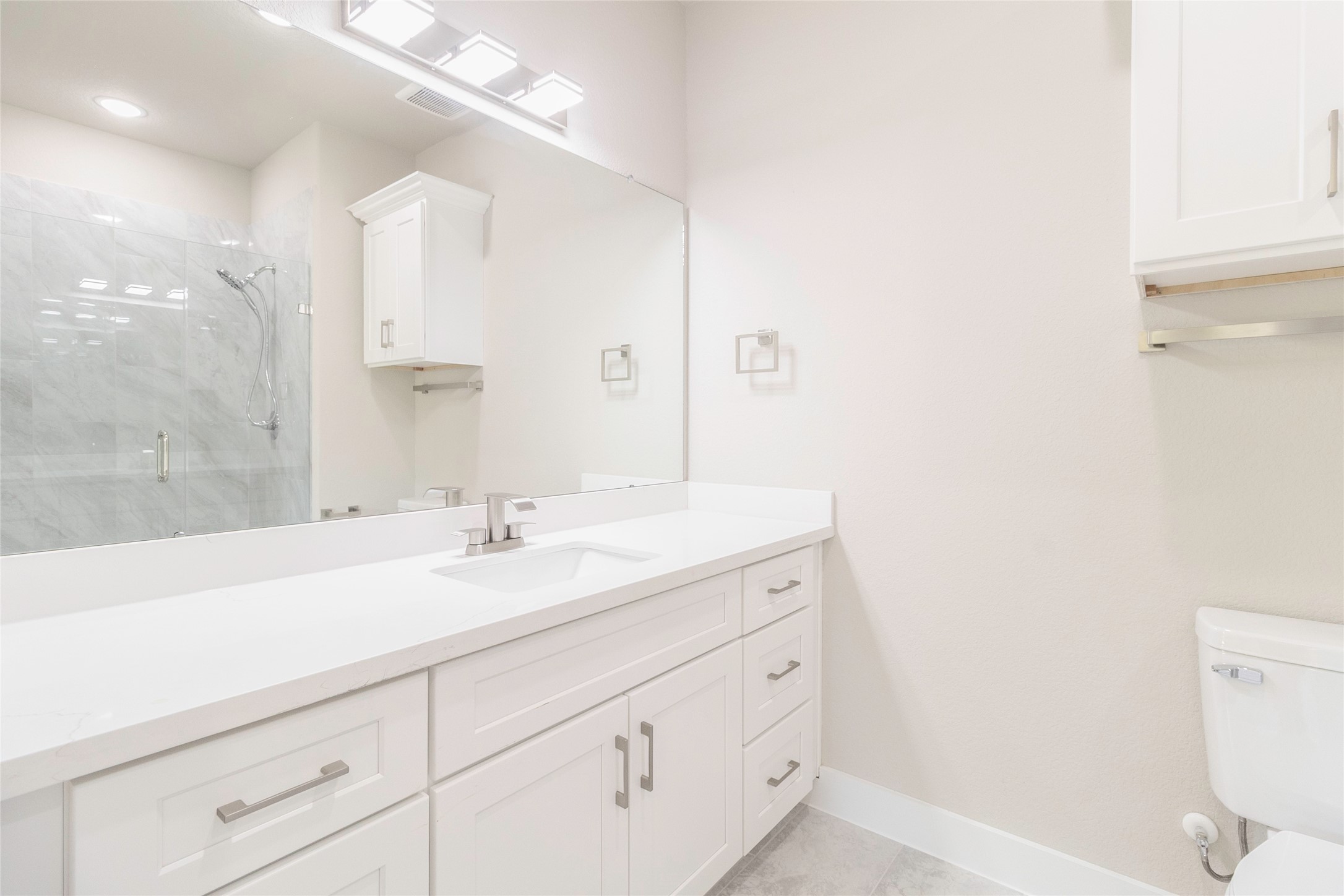 9821 Richcroft Street Houston, TX 77029 - Photo 12 of 15 a bathroom with a sink a toilet and a mirror