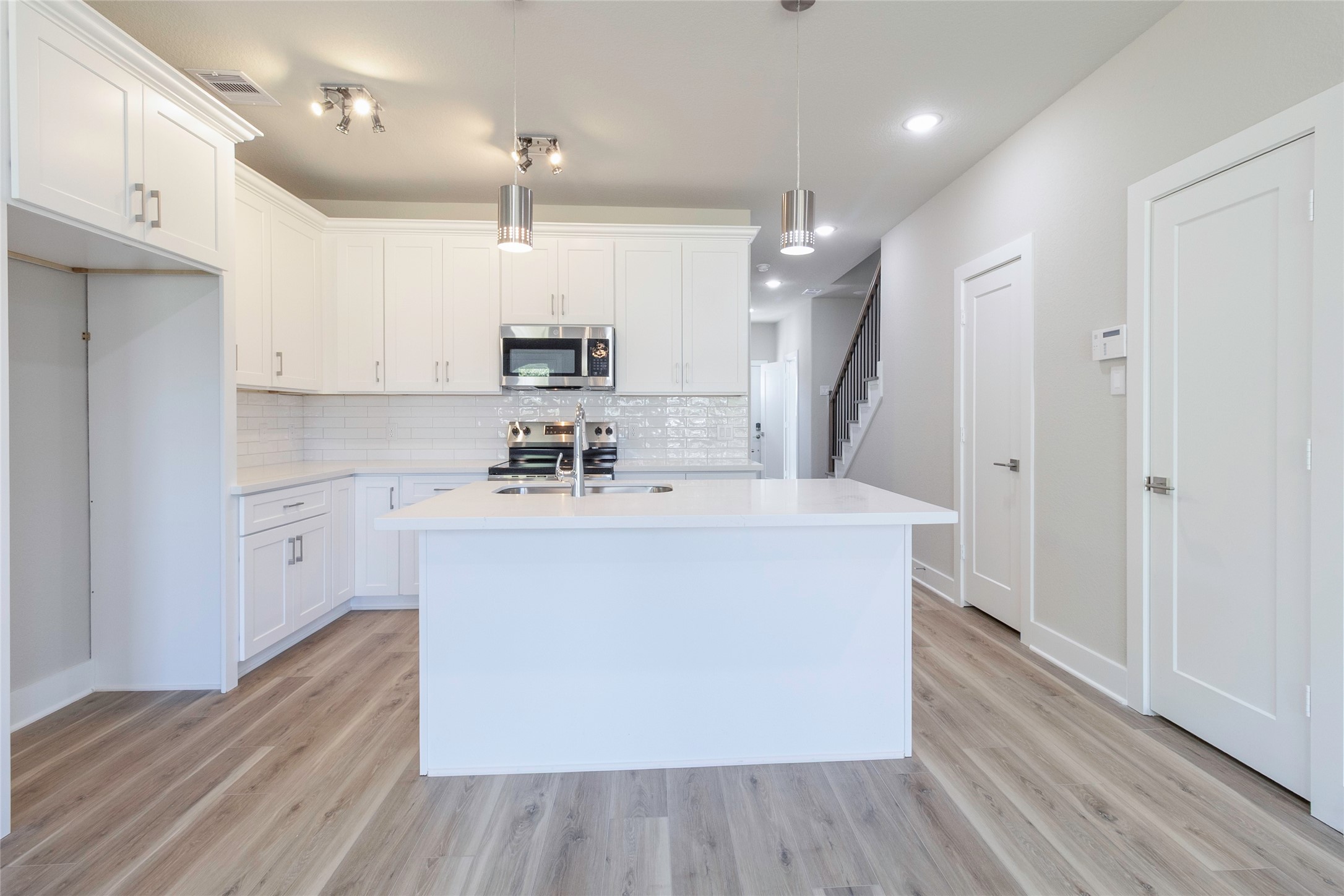 9821 Richcroft Street Houston, TX 77029 - Photo 6 of 15 a view of kitchen with stainless steel appliances sink refrigerator and microwave