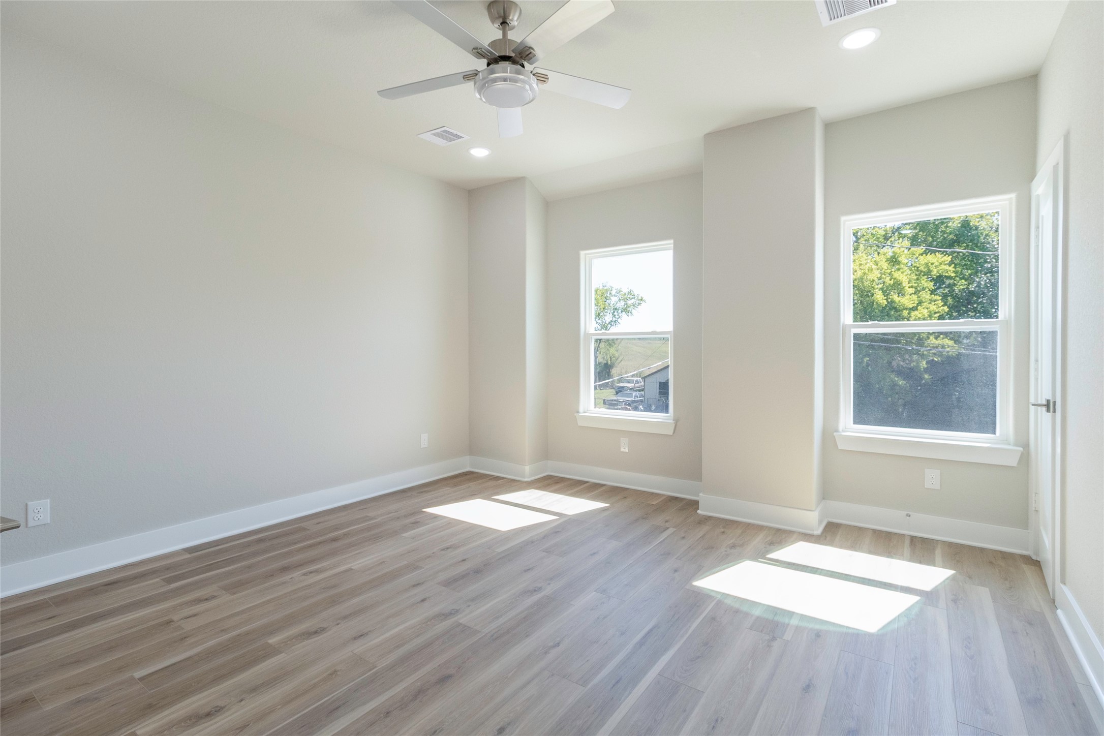 9821 Richcroft Street Houston, TX 77029 - Photo 9 of 15 wooden floor in an empty room with a window
