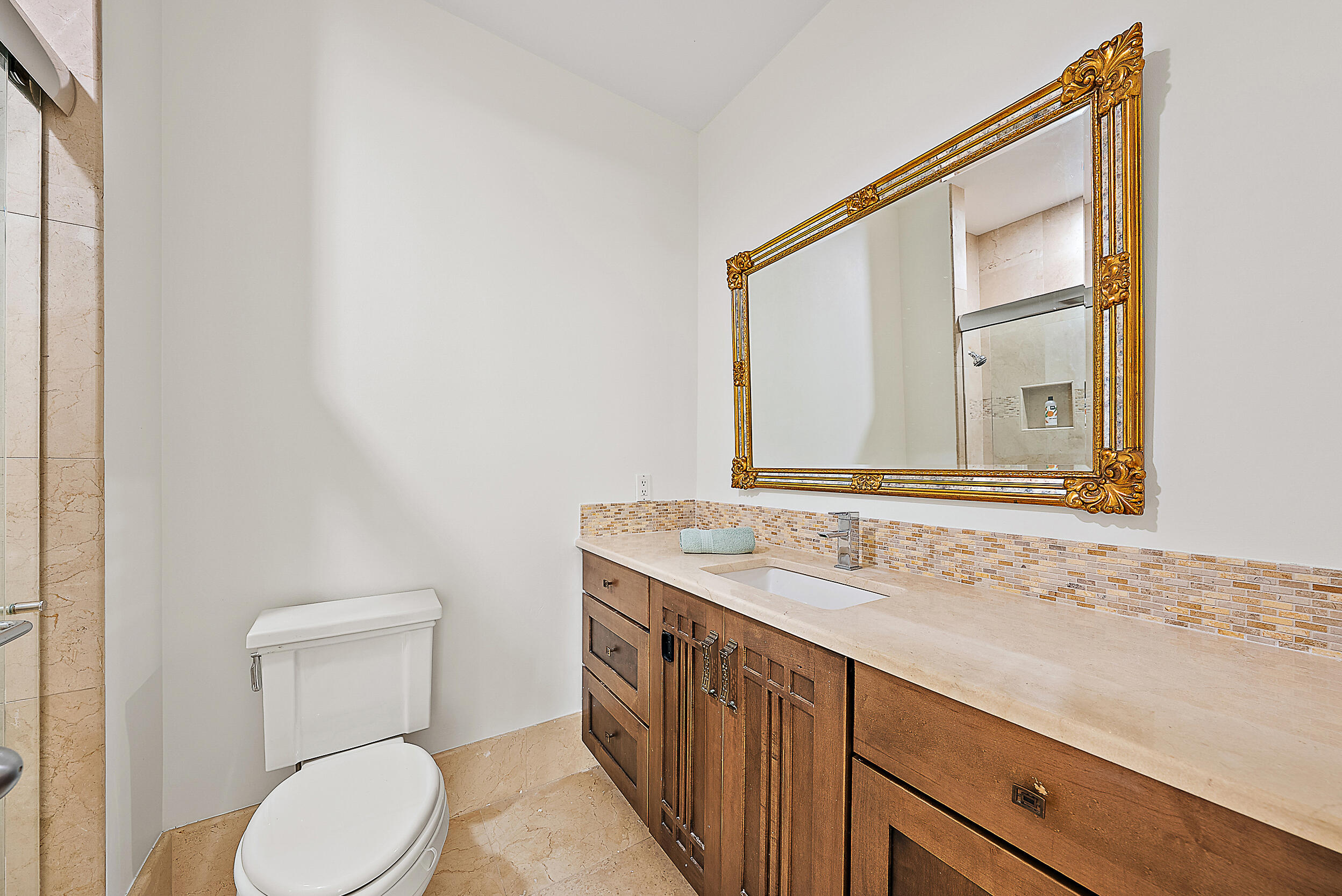 167 North Village Way Jupiter, FL 33458 - Photo 19 of 30 a bathroom with a granite countertop sink toilet and mirror