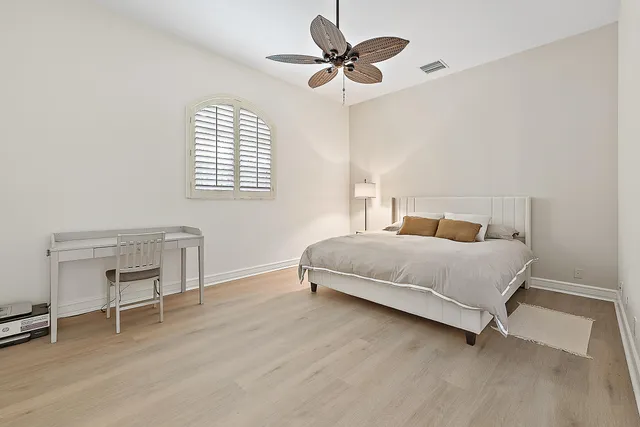 a bedroom with a bed and a chair