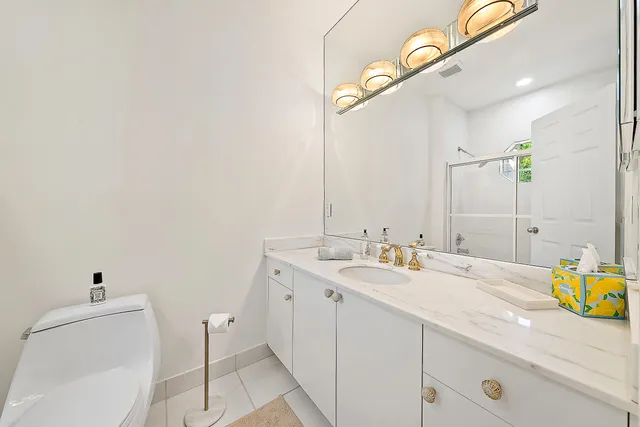 a bathroom with a granite countertop sink mirror and vanity