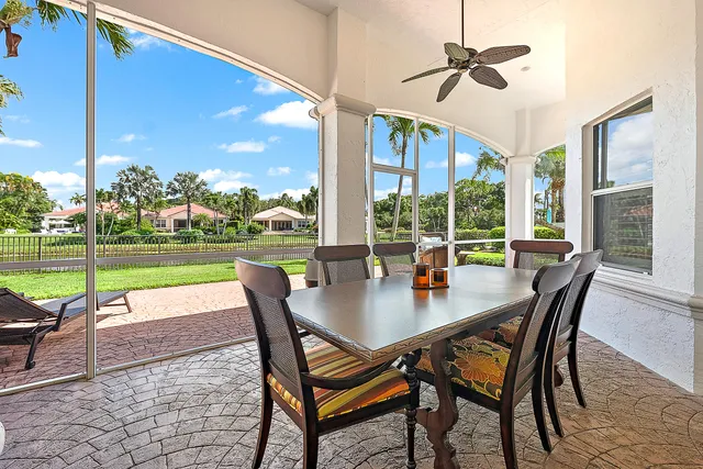 a dining room with furniture and a floor to ceiling window