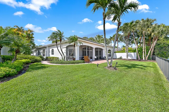 a view of a house with a backyard porch and sitting area