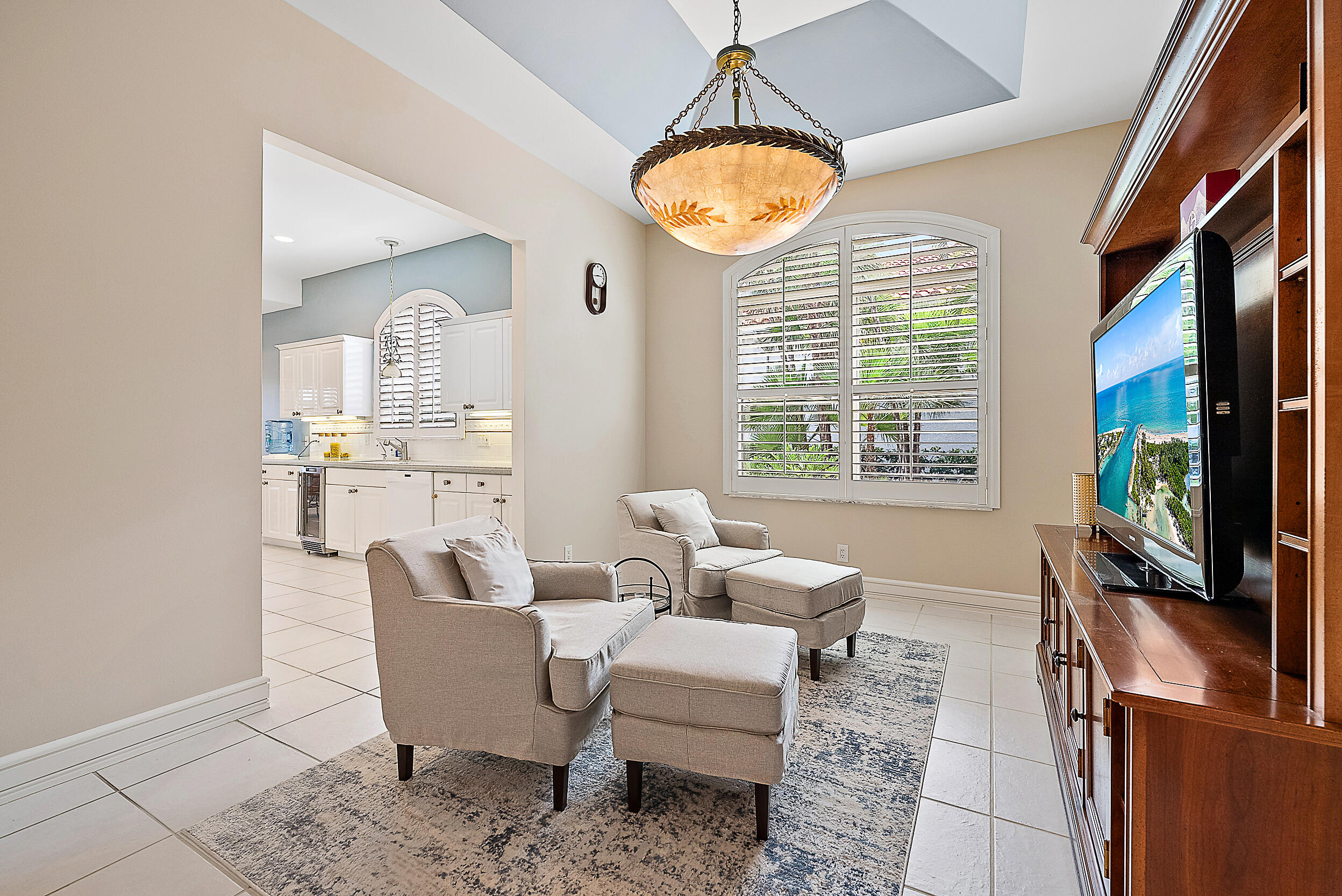 167 North Village Way Jupiter, FL 33458 - Photo 8 of 30 a living room with furniture a flat screen tv and a large window