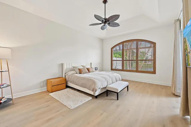 a spacious bedroom with a bed and a window