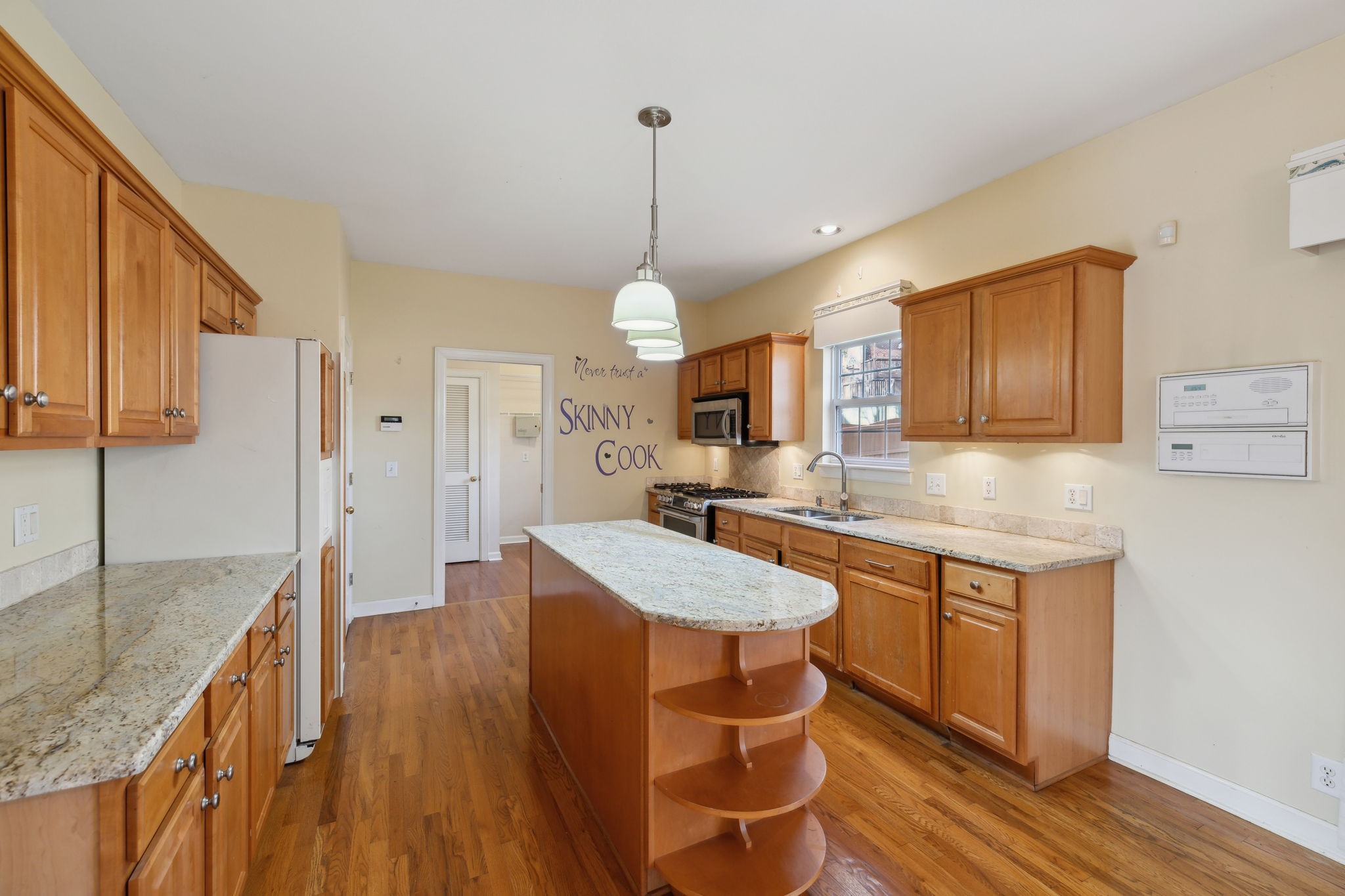 8012 Poplarwood Road Nashville, TN 37221 - Photo 11 of 32 a kitchen with stainless steel appliances granite countertop a sink stove and wooden floor
