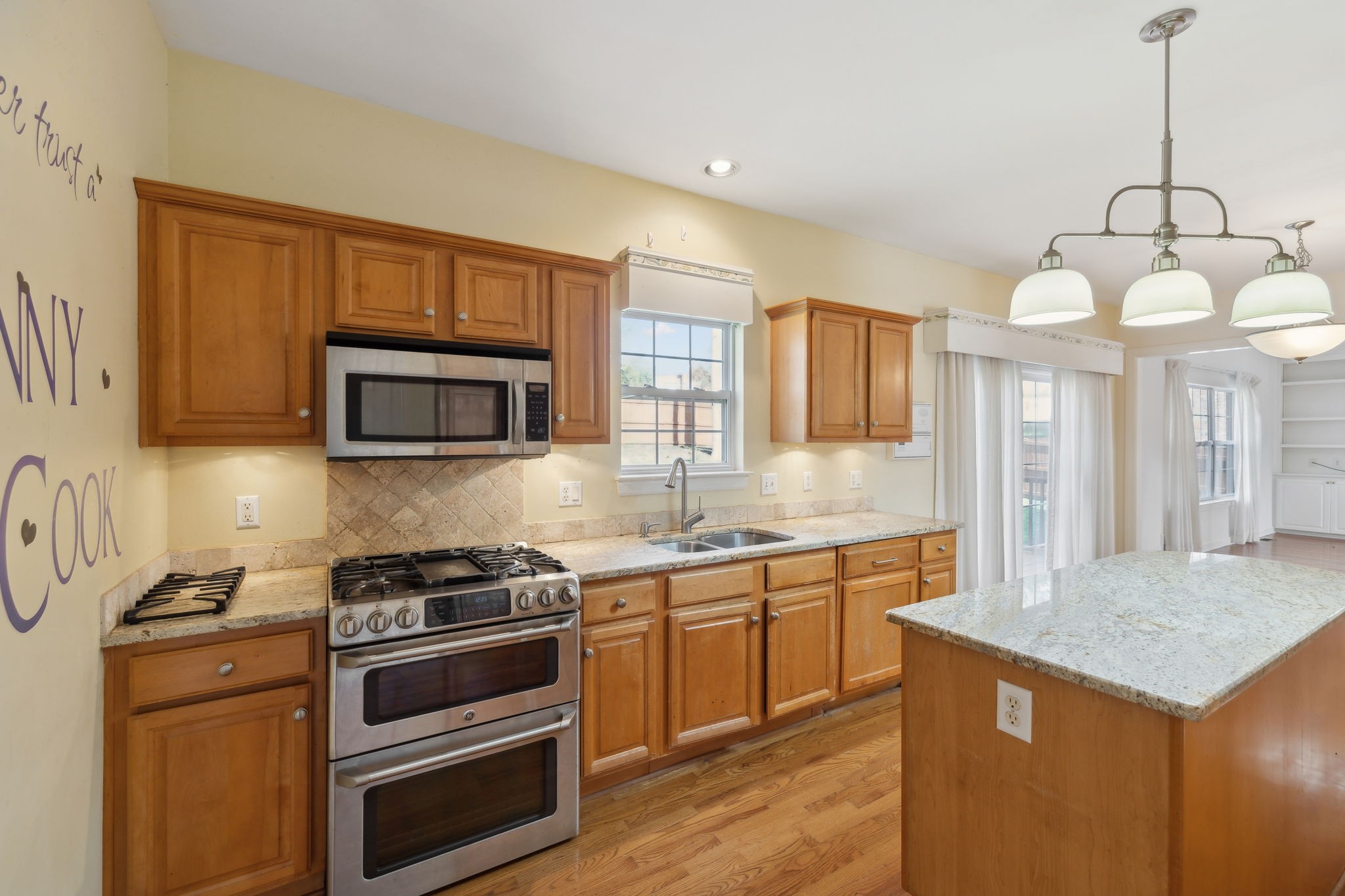 8012 Poplarwood Road Nashville, TN 37221 - Photo 13 of 32 a kitchen with granite countertop a stove and a sink
