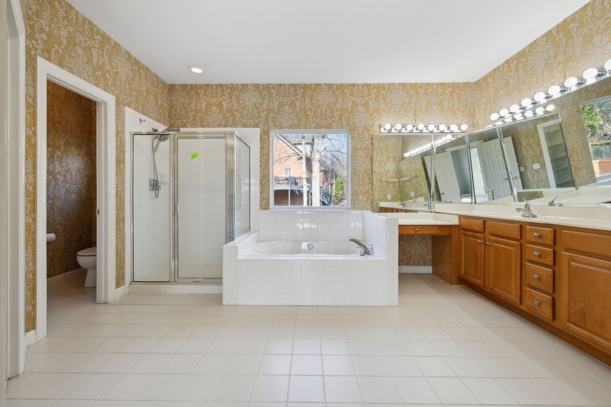 8012 Poplarwood Road Nashville, TN 37221 - Photo 21 of 32 a bathroom with a tub a sink shower and mirror