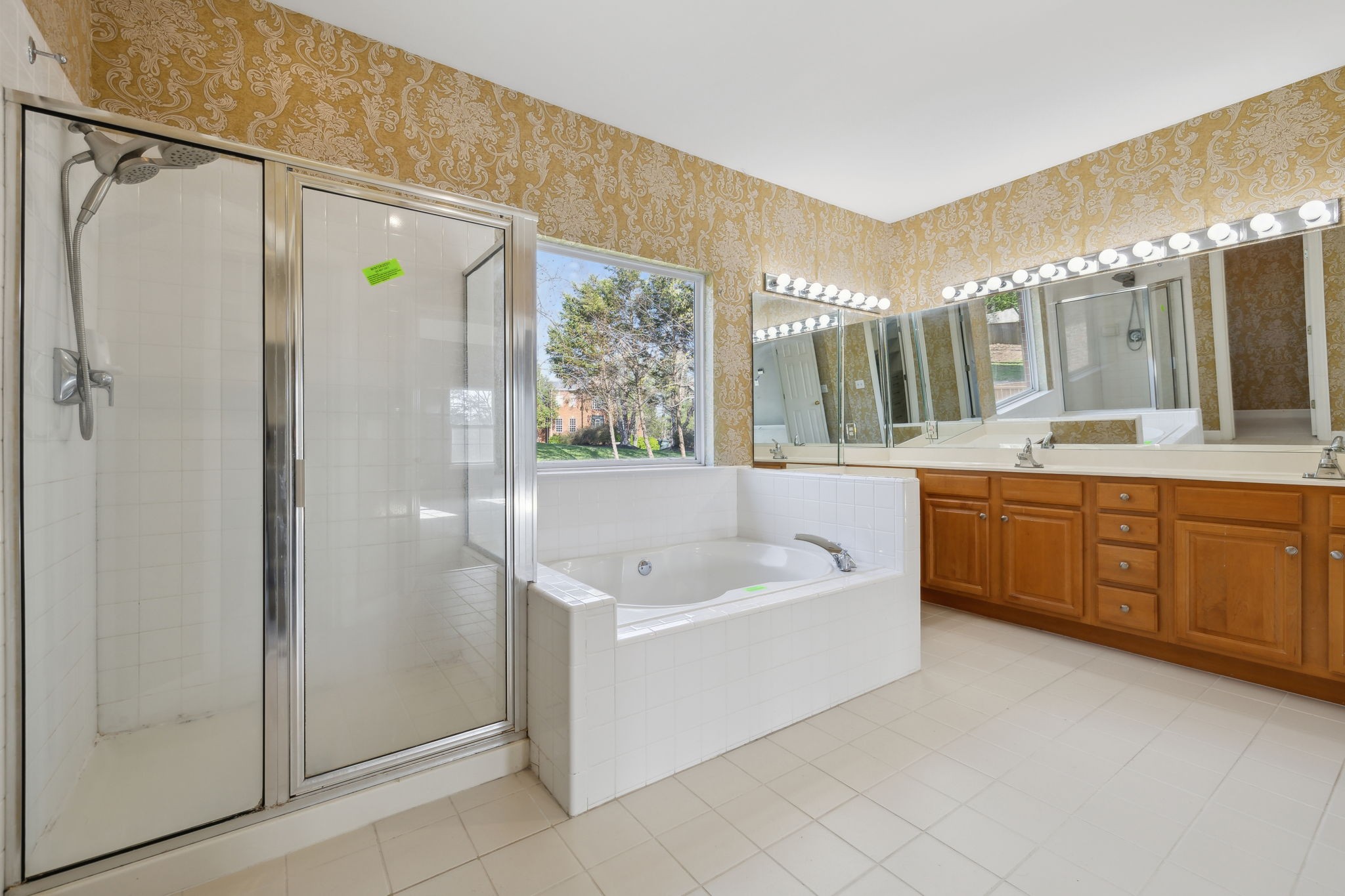 8012 Poplarwood Road Nashville, TN 37221 - Photo 23 of 32 a bathroom with a tub a sink shower and mirror
