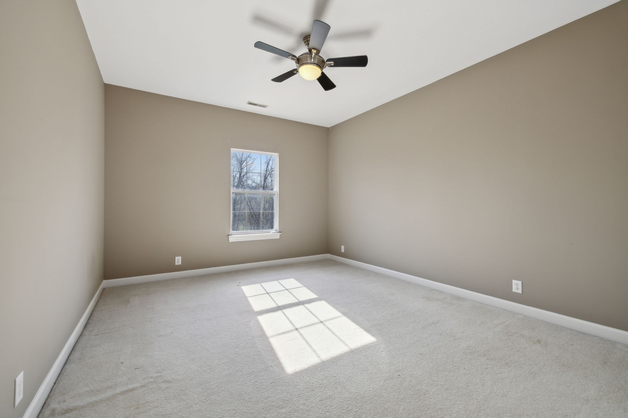 8012 Poplarwood Road Nashville, TN 37221 - Photo 26 of 32 an empty room with windows and fan