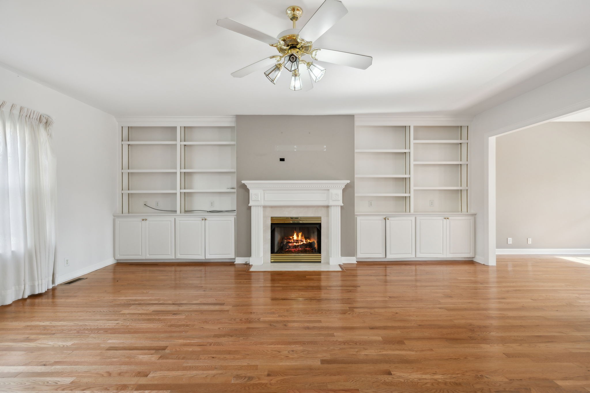 8012 Poplarwood Road Nashville, TN 37221 - Photo 4 of 32 a view of an empty room with a fireplace and a window