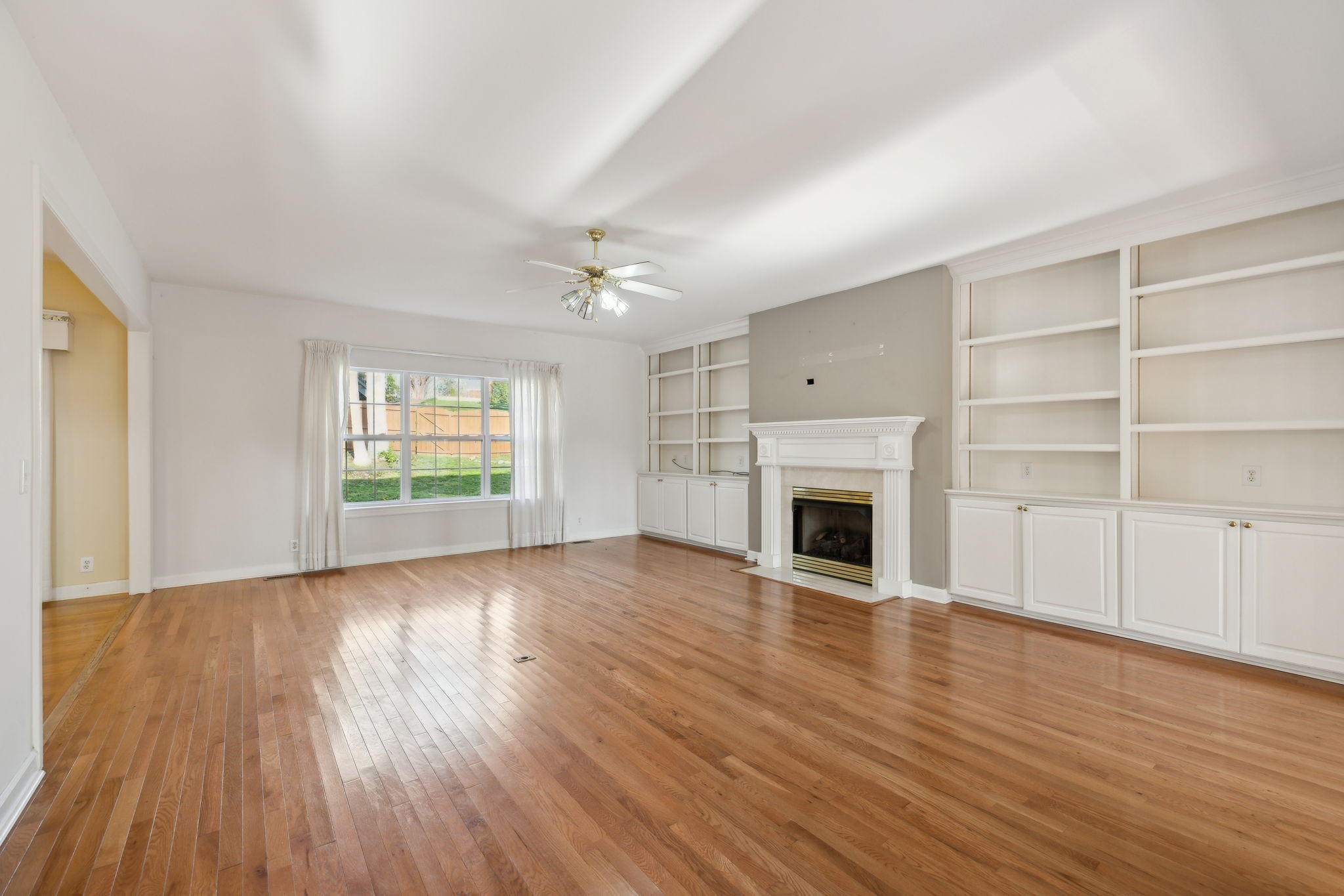 8012 Poplarwood Road Nashville, TN 37221 - Photo 7 of 32 wooden floor fireplace and windows in an empty room