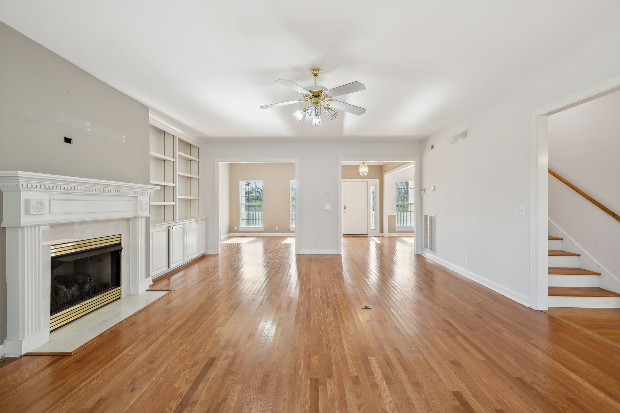 8012 Poplarwood Road Nashville, TN 37221 - Photo 9 of 32 a view of an empty room with wooden floor fireplace and a window