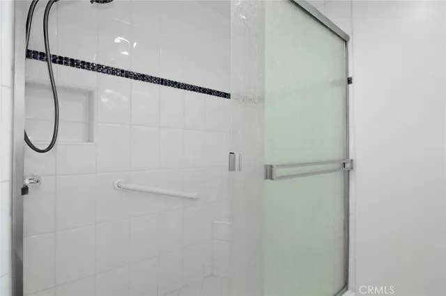 a view of a house with a small yard and a large tree