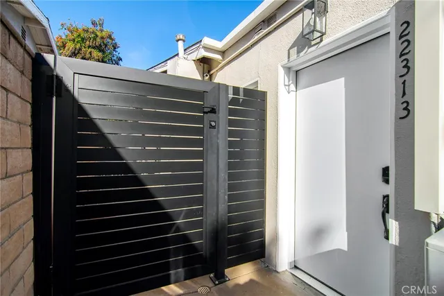 a kitchen with a refrigerator and a stove top oven
