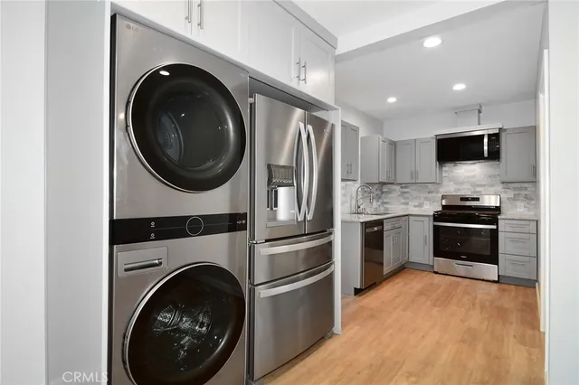 a kitchen with stainless steel appliances granite countertop a refrigerator and a stove