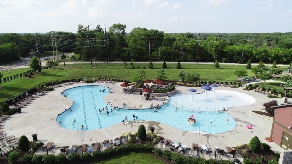 a view of a swimming pool with a yard and outdoor seating