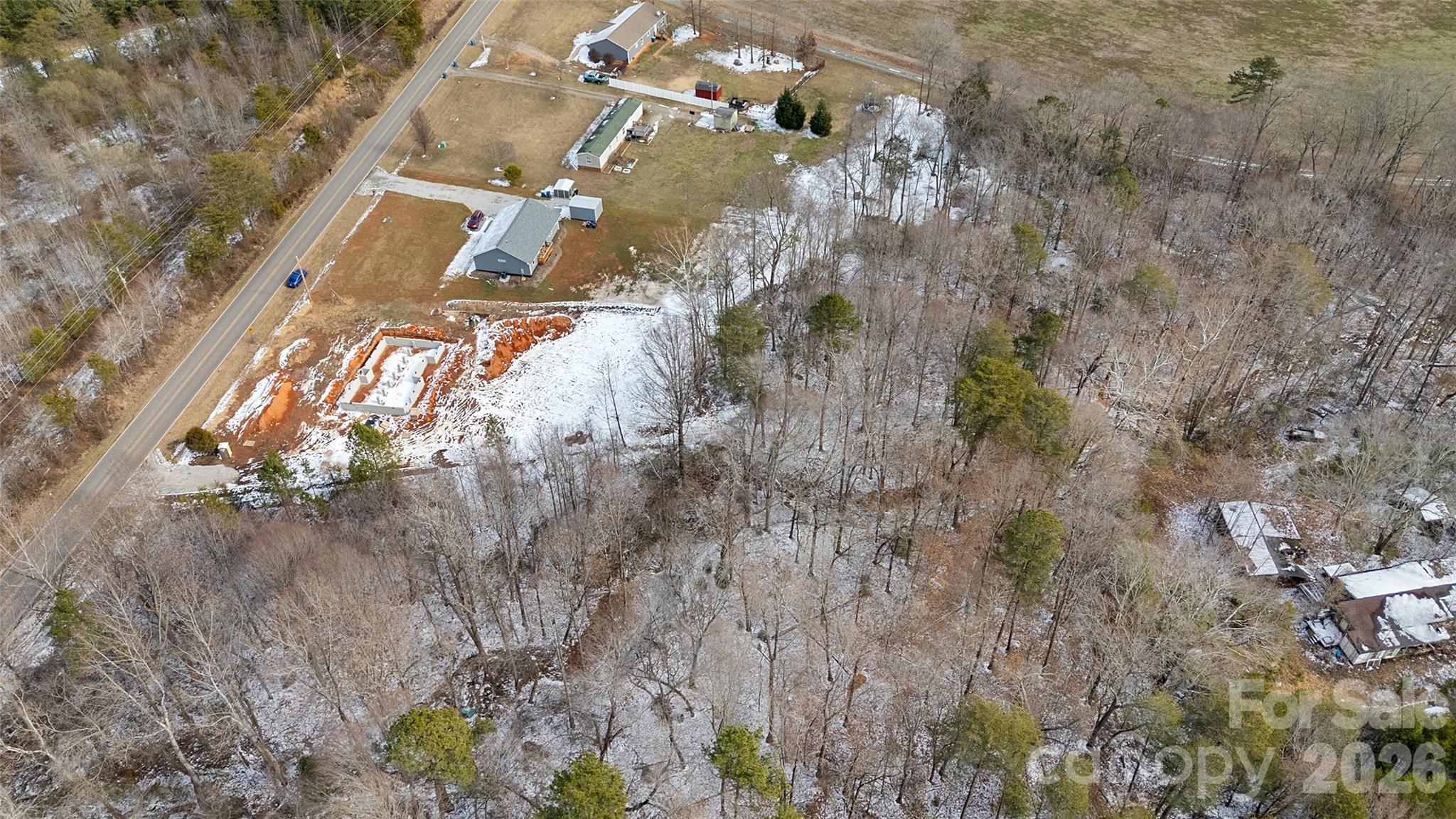 6399 Little Mountain Road, Unit 1 Sherrills Ford, NC 28673 - Photo 20 of 40 a view of a yard with plants and large trees