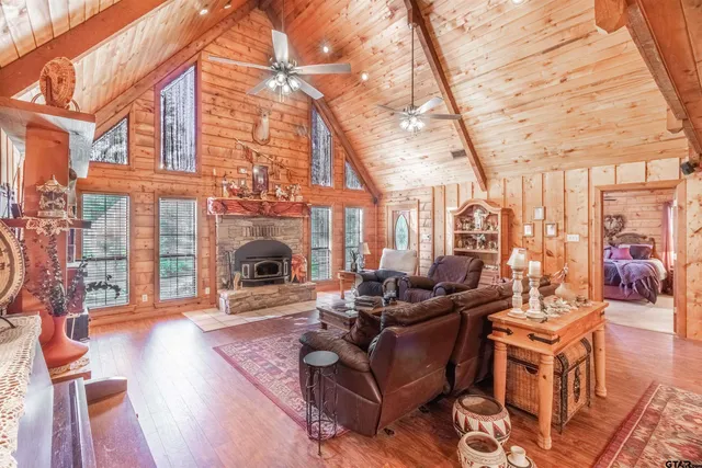 a living room with furniture a fireplace and a floor to ceiling window