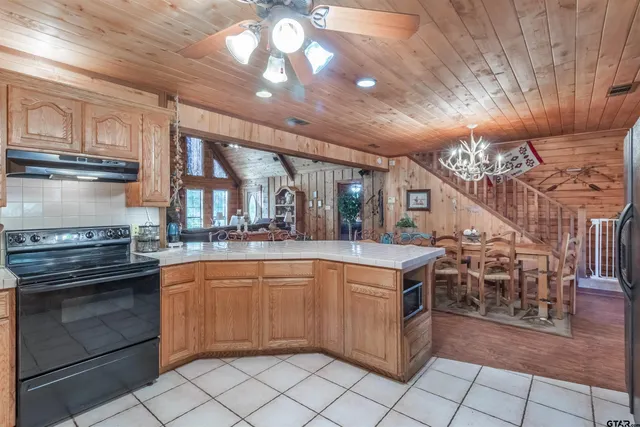 a kitchen with stainless steel appliances granite countertop a stove and a sink