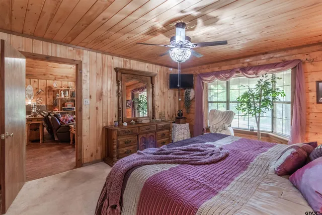 a bedroom with a large bed and a large window
