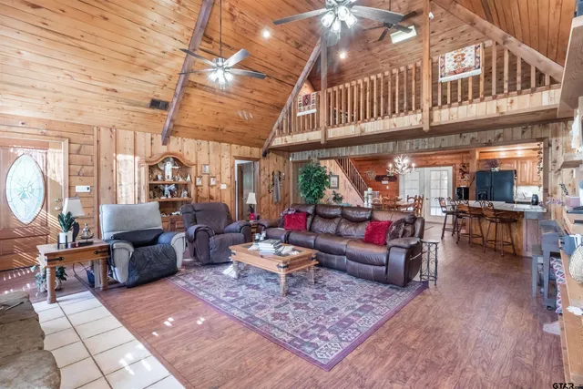 a living room with furniture a rug and a chandelier