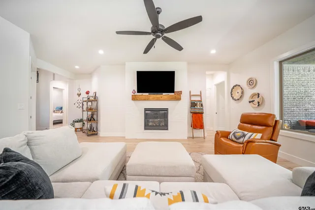 a living room with furniture and a large window