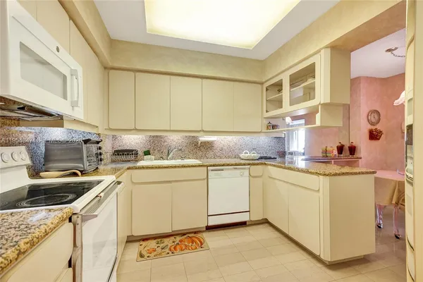 a bathroom with a granite countertop sink mirror and shower