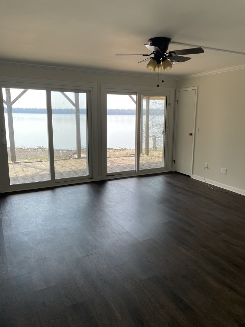 3512 Riverview Lake Road Metropolis, IL 62960 - Photo 3 of 20 a view of an empty room with a window and wooden floor