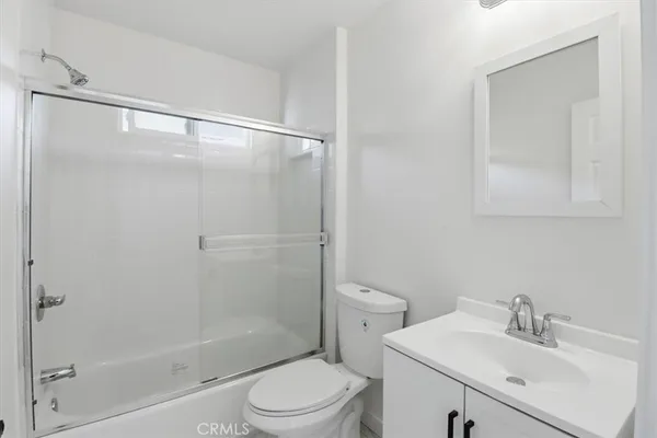a bathroom with a sink mirror vanity and toilet