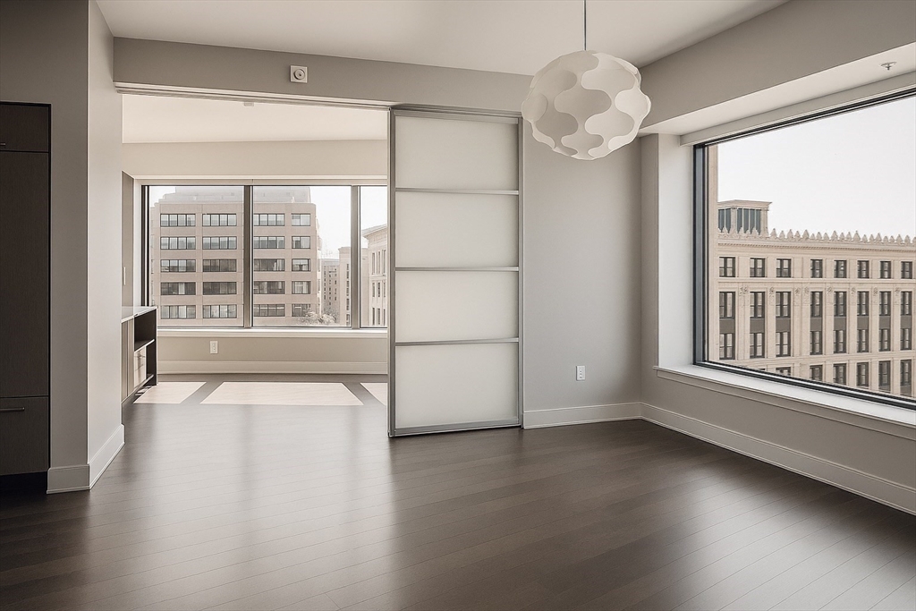 110 Stuart Street, Unit 16H Boston, MA 02116 - Photo 6 of 22 an empty room with wooden floor and windows