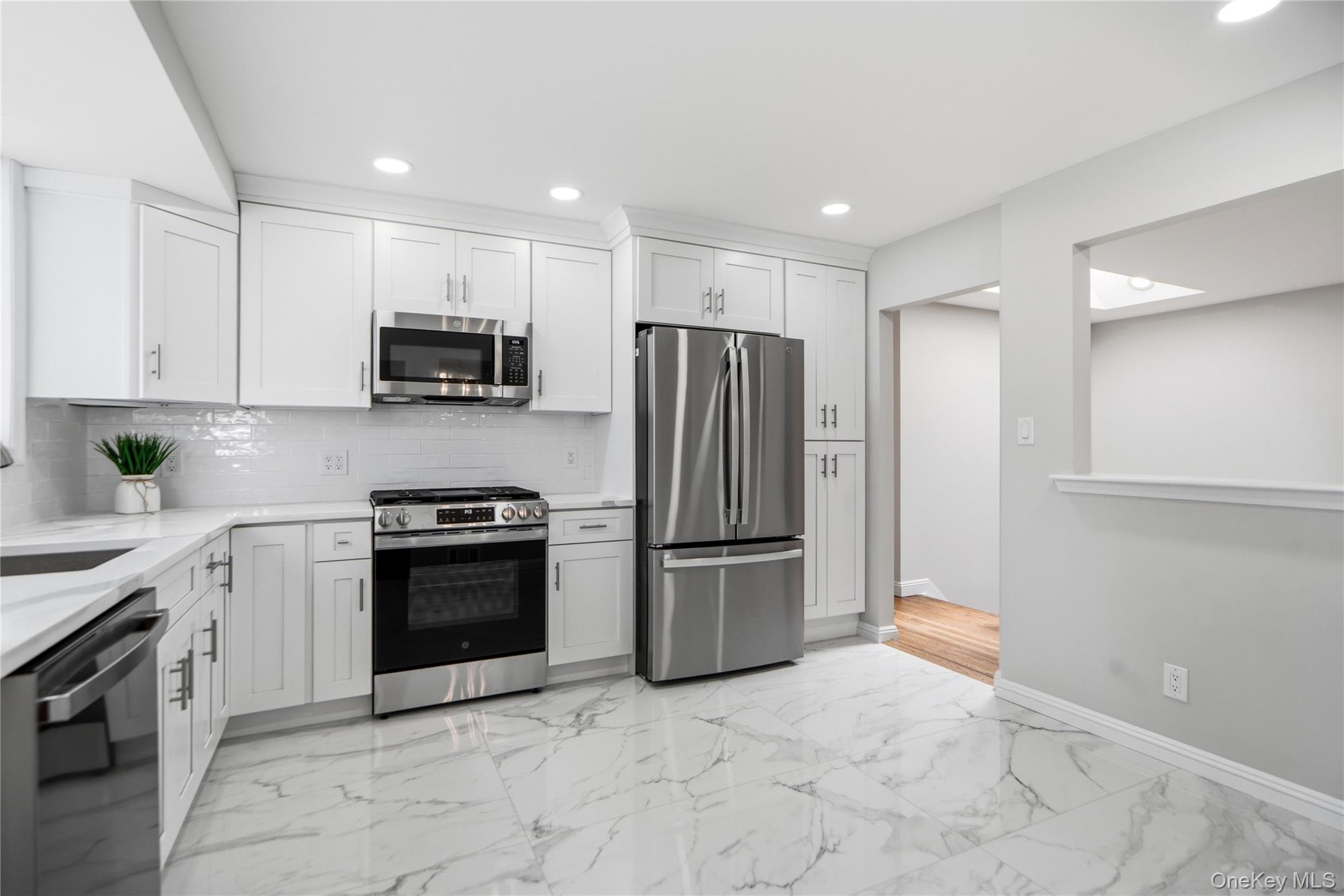 183 North Marginal Road Jericho, NY 11753 - Photo 12 of 28 Eat in Kitchen with New Porcelain Floors, Backsplash and Quartz Countertops with all New appliances