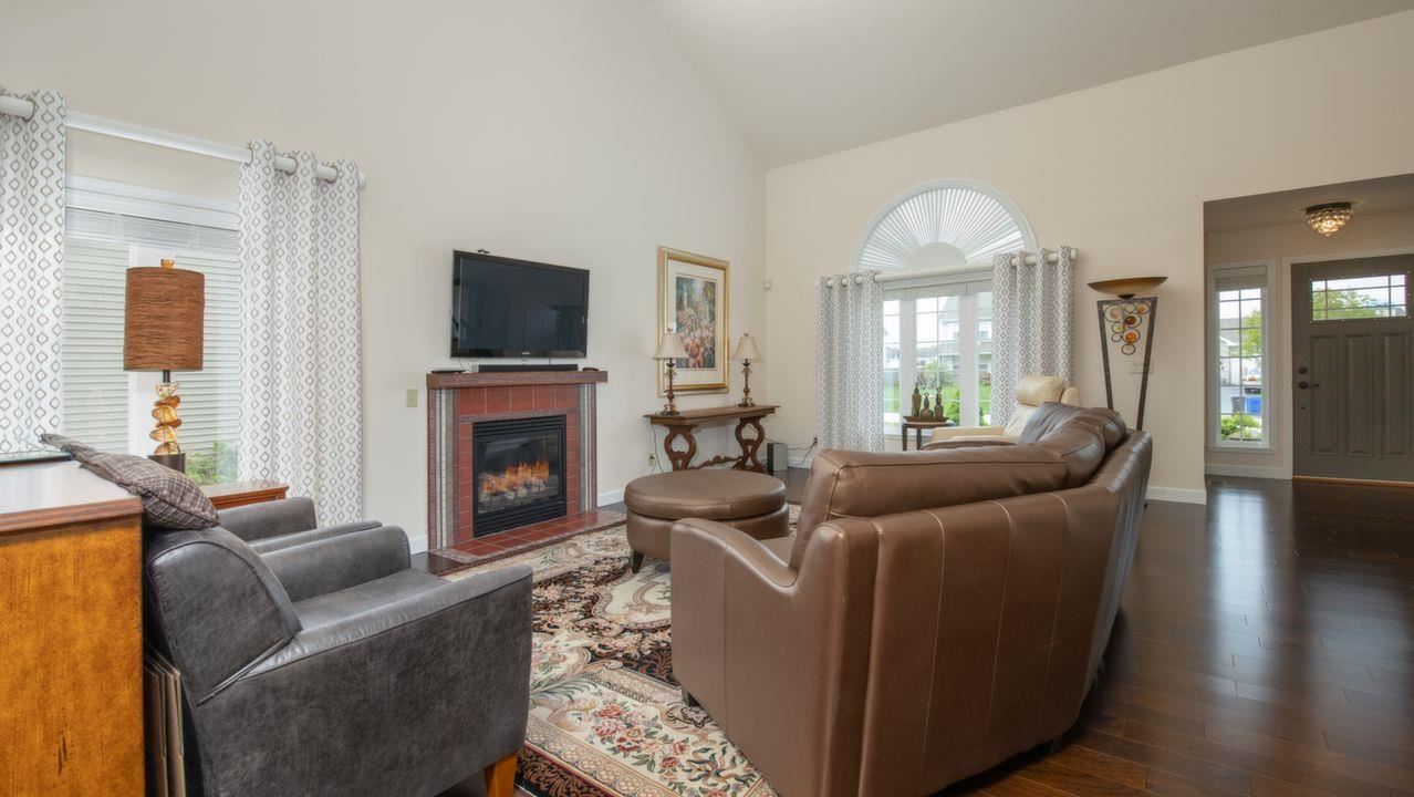 11105 Chicory Ridge Way Roscoe, IL 61073 - Photo 5 of 35 a living room with furniture a flat screen tv and a fireplace