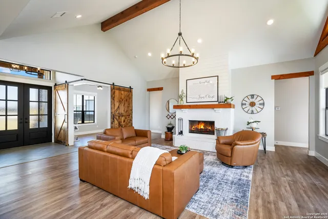 a living room with fireplace furniture and a wooden floor
