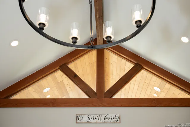 a living room with furniture a fireplace and kitchen view