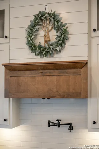 a kitchen with sink stove and cabinets