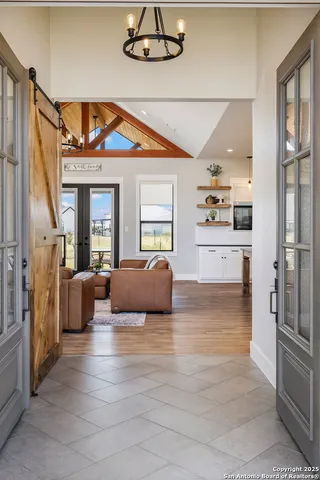 a living room with furniture and a chandelier