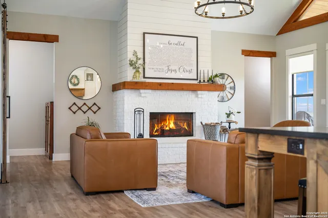 a living room with furniture a window and a fireplace