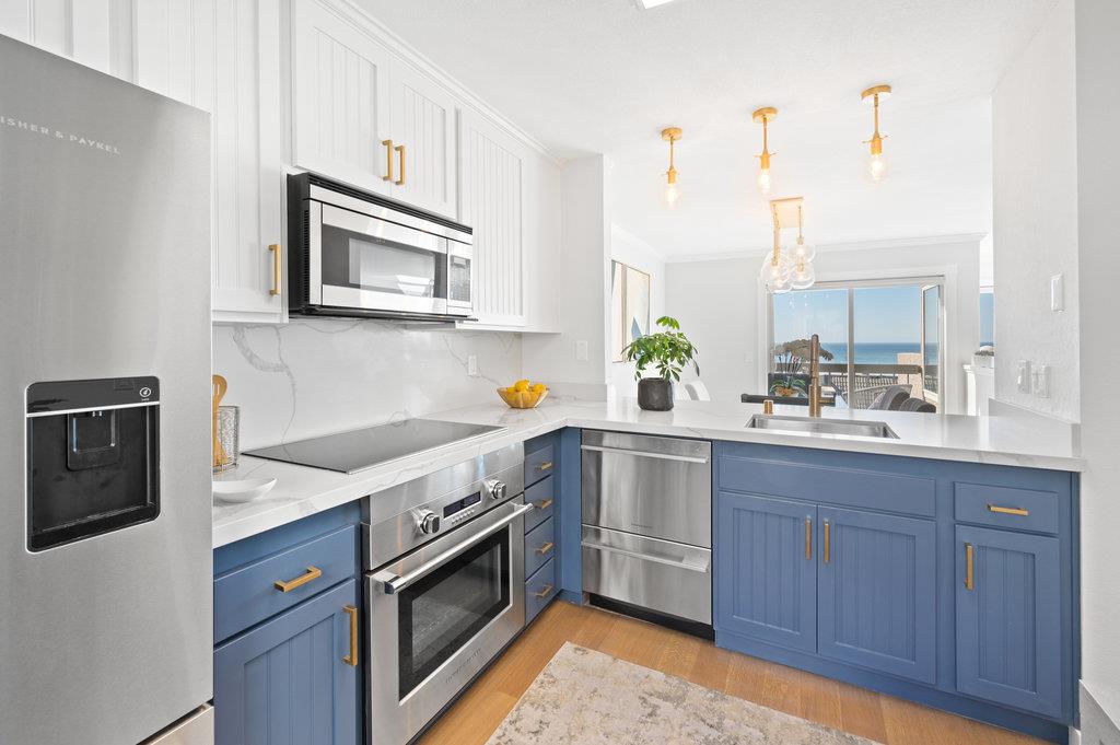 415 Roberts Road Pacifica, CA 94044 - Photo 26 of 69 a kitchen with stainless steel appliances granite countertop a sink stove and microwave