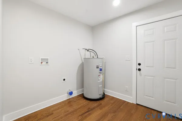 a room with wooden floor and white walls